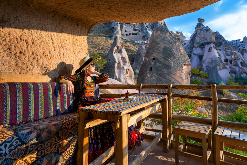 Woman,In,Bohemian,Dress,Sitting,On,Traditional,Cave,House,In