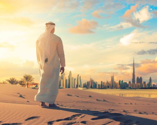Arab,Man,Standing,Front,Dubai,Skyline,In,The,Desert,Of
