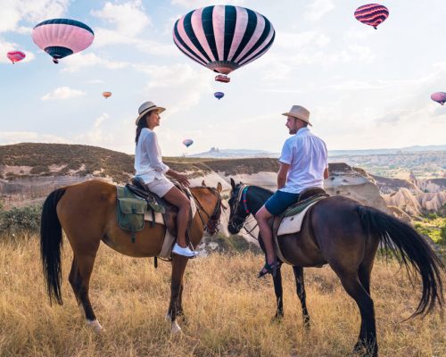 Happy,Young,Couple,On,Vacation,Turkey,Kapadokya,Horse,Riding,In