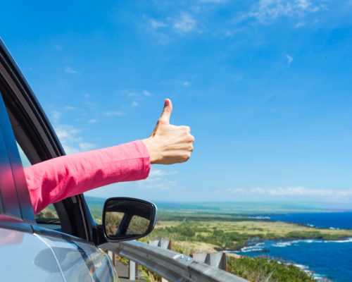 Happy,Traveler.,Woman,With,Thumbs,Up,Out,Her,Car,Window.