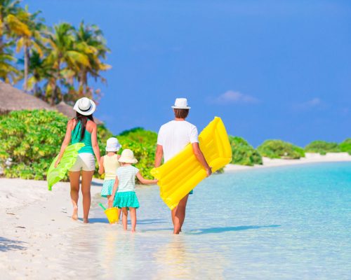 Happy,Beautiful,Family,On,A,Beach,During,Summer,Vacation
